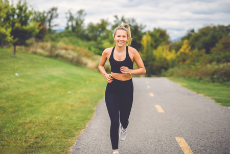 Front view of a happy runner teen doing jogging