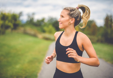 Front view of a happy runner teen doing jogging