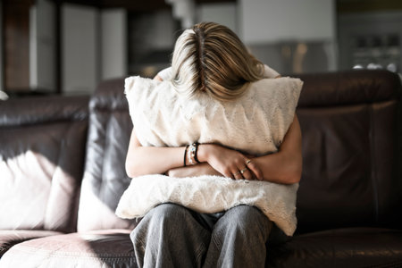 teen Girl sitting on a couch at homeの写真素材