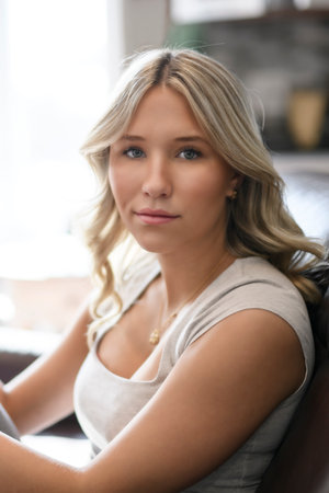 teen Girl sitting on a couch at homeの写真素材