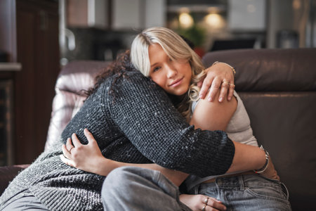 Compassionate mother comforting sad teen girl, hugging daughter with love