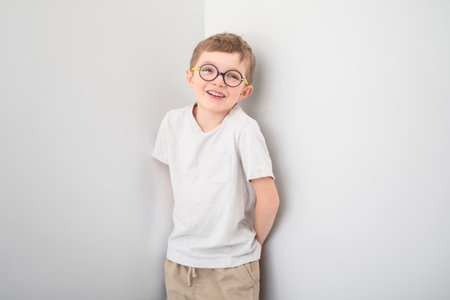 portrait of handsome little boy in glasses isolated on gray backgroundの写真素材