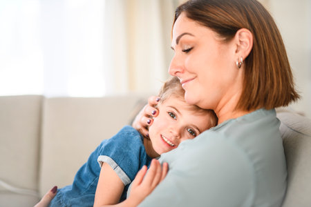Happy mom and adult daughter woman having fun at home, hugging with heads touch.の写真素材