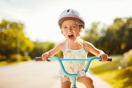 kid girl of 4 years cycling on the bicycleの写真素材