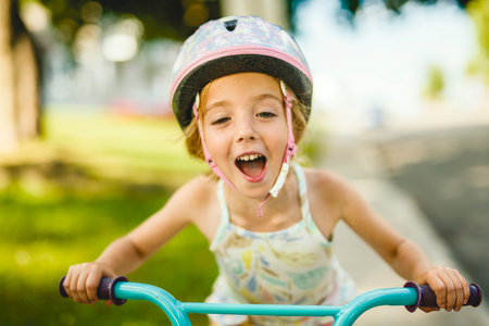 kid girl of 4 years having fun when cycling on the bicycleの写真素材