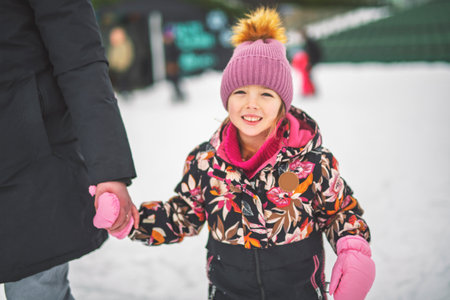 little girl enjoying ice skating in winter seasonの写真素材