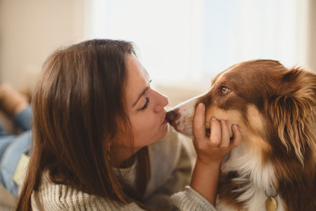 woman with cute fluffy dog at home in living roomの写真素材