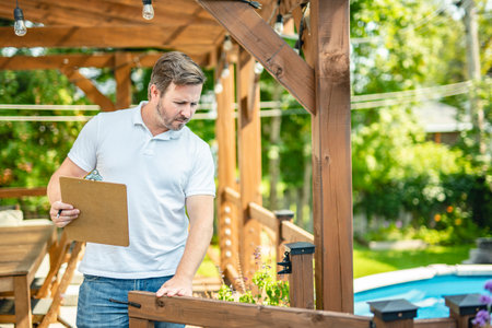 Safety fence at swimmimg pool with worker inspection menの写真素材