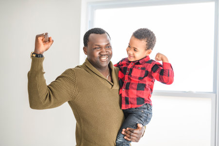 Happy Black American father with little boy at homeの写真素材