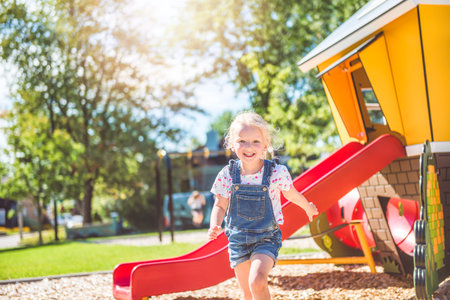 Happy kid on playground on summer seasonの写真素材
