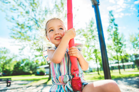 Happy kid on playground on summer seasonの写真素材