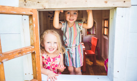 Happy kid having fun play together on summer season on a little child houseの写真素材