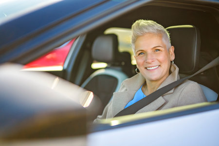 Happy owner. Mature woman sitting relaxed in his newly bought car.