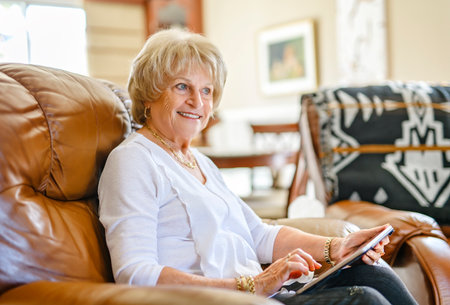 Senior Woman Doing Crossword Puzzle At Homeの写真素材