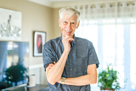Portrait of retired senior man standing at home.の写真素材