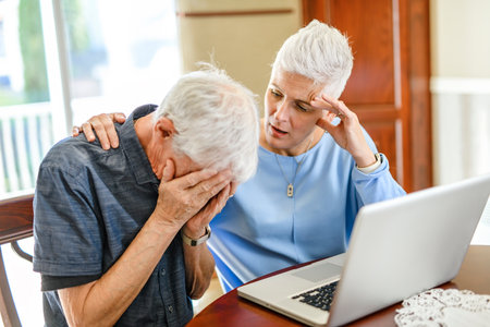 daughter explaining some documentation to senior parentの写真素材
