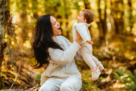 mother with baby girl in autumn in beautiful forest