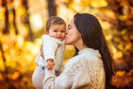 mother with baby girl in autumn in beautiful forest