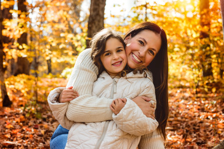 mother with four years girl in autumn beautiful forestの写真素材