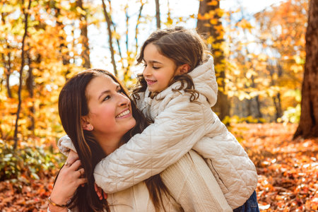 mother with four years girl in autumn beautiful forestの写真素材