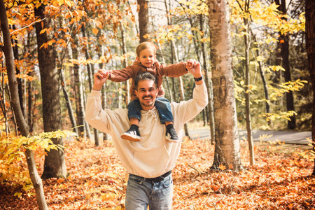 father with little boy in autumn beautiful forestの写真素材