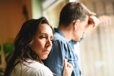 couple enjoying quiet time close to a window. The man crying and woman consoling