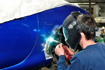 worker welding car body worker welding car body