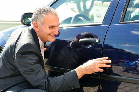 Insurance agent inspecting a car の写真素材