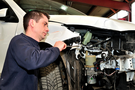 Mechanic take damaged car apart.の写真素材