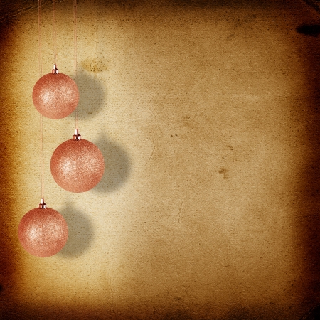 Christmas balls hanging on the old paper backgroundの写真素材