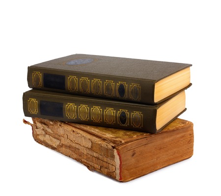 A stack of old books with gold stamping on a white background isolatedの写真素材