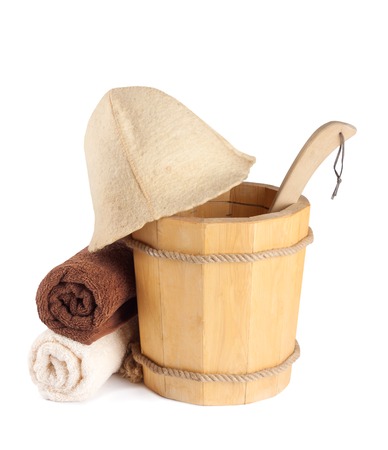 Wooden bucket with ladle and towels for the sauna Isolated on white の写真素材