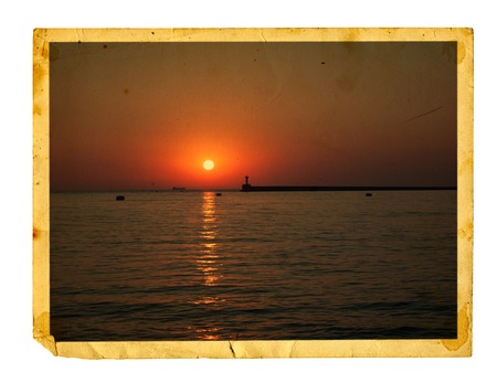 Old vintage card with a beautiful sea sunset on a white background isolated