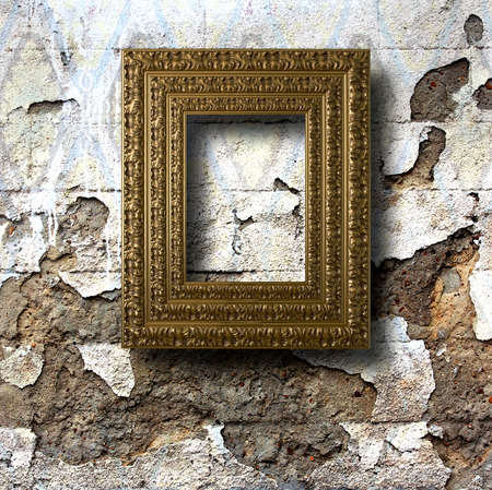 Gilded wooden frames for pictures on old stone wallの写真素材