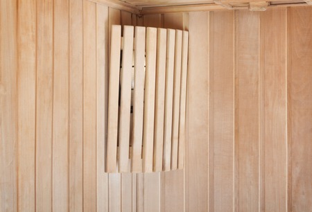 Bright lamp on the wall of  traditional wooden saunaの写真素材