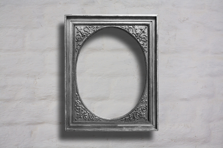 Silver wooden frames for pictures on old brick stone wallの写真素材