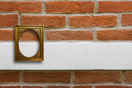 Gilded wooden frame for pictures on old brick stone wall