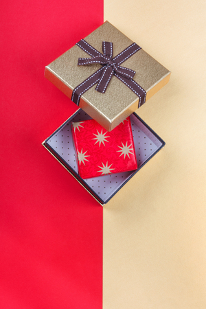 Golden gift box on  bright red background.Top view flat lay group objectsの写真素材