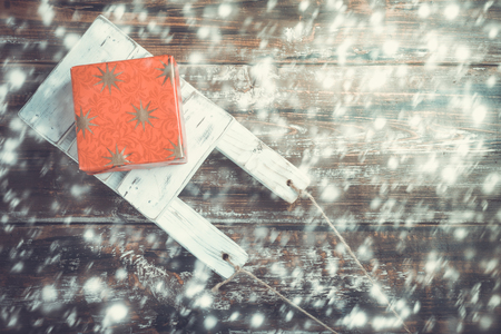 Old wooden toy sled with gift boxes on  wooden background. Top View Flat Lay Group Objectsの写真素材