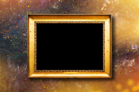 Old vintage gold ornate frame for picture on grunge stone wallの写真素材