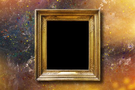 Old vintage gold ornate frame for picture on grunge stone wallの写真素材