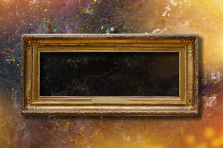 Old vintage gold ornate frame for picture on grunge stone wallの写真素材