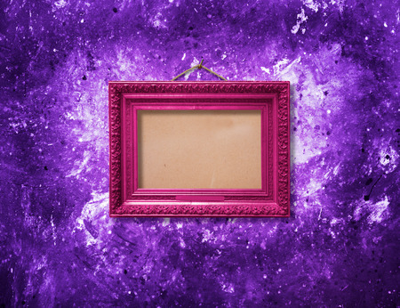 Old vintage multicolored ornate frame for picture on grunge stone wallの写真素材