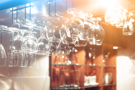 Empty  glasses hanging above the bar in the restaurant. Night lifeの写真素材