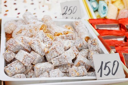 Assortment of delicious marmalade jelly candies  for sale on counter of shop, market, cafe. Variety...