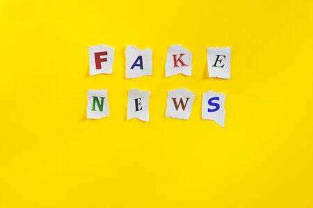 Paper art banner on yellow backdrop in style zine wiht words fake news. Fake in flat style.の写真素材