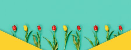 Beautiful card with yellow and red tulips for congratulation invitation or banner.
Flat lay Top view...