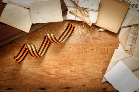 Victory Day - 9 of may 1945. St. George Ribbon, front-line letters album photos and post card of the Second World War on  vintage wooden table. Flat lay Top view with copy space for  your text.の写真素材