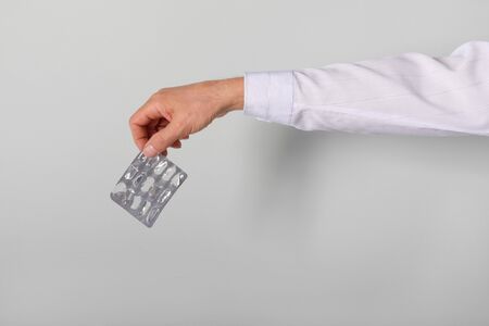 Man throws used gloves and mask in bucket after coronavirus pandemic. Concept.の写真素材