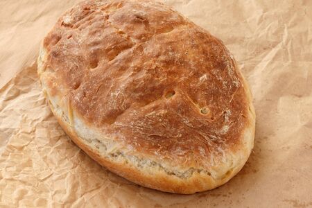 Fresh homemade wheat bread on  wooden table.  Flat lay, top view, copy space concept.